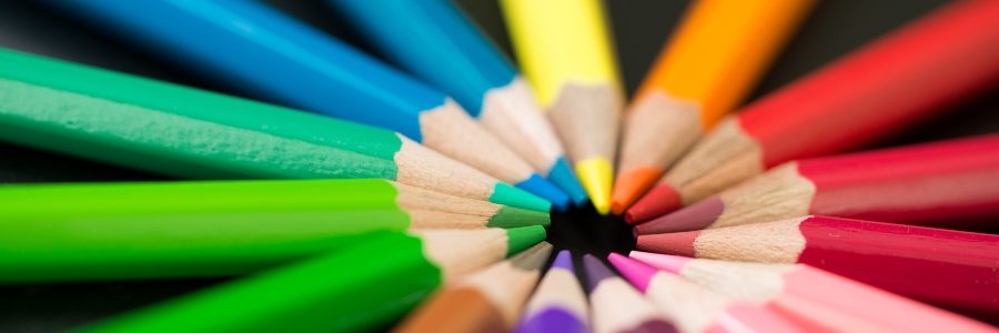 Color pencils arranged in round circle on black background