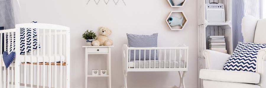 Spacious baby room with simple white furniture and beautiful marine decorations